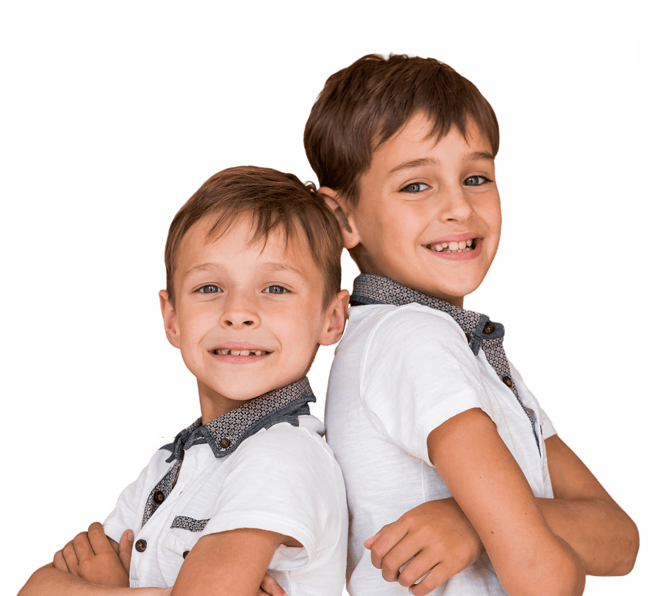 Two children smiling after pediatric dental care