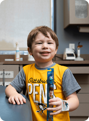 A child smiling during a pediatric dental appointment